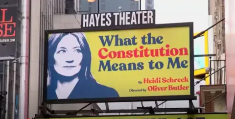 Billboard on the street says "Hayes Theater: What the Constitution Means to Me"