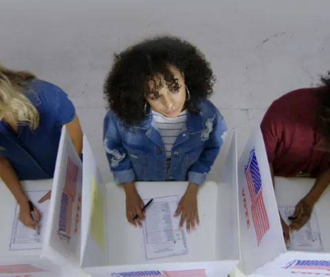 Picture of three people voting.